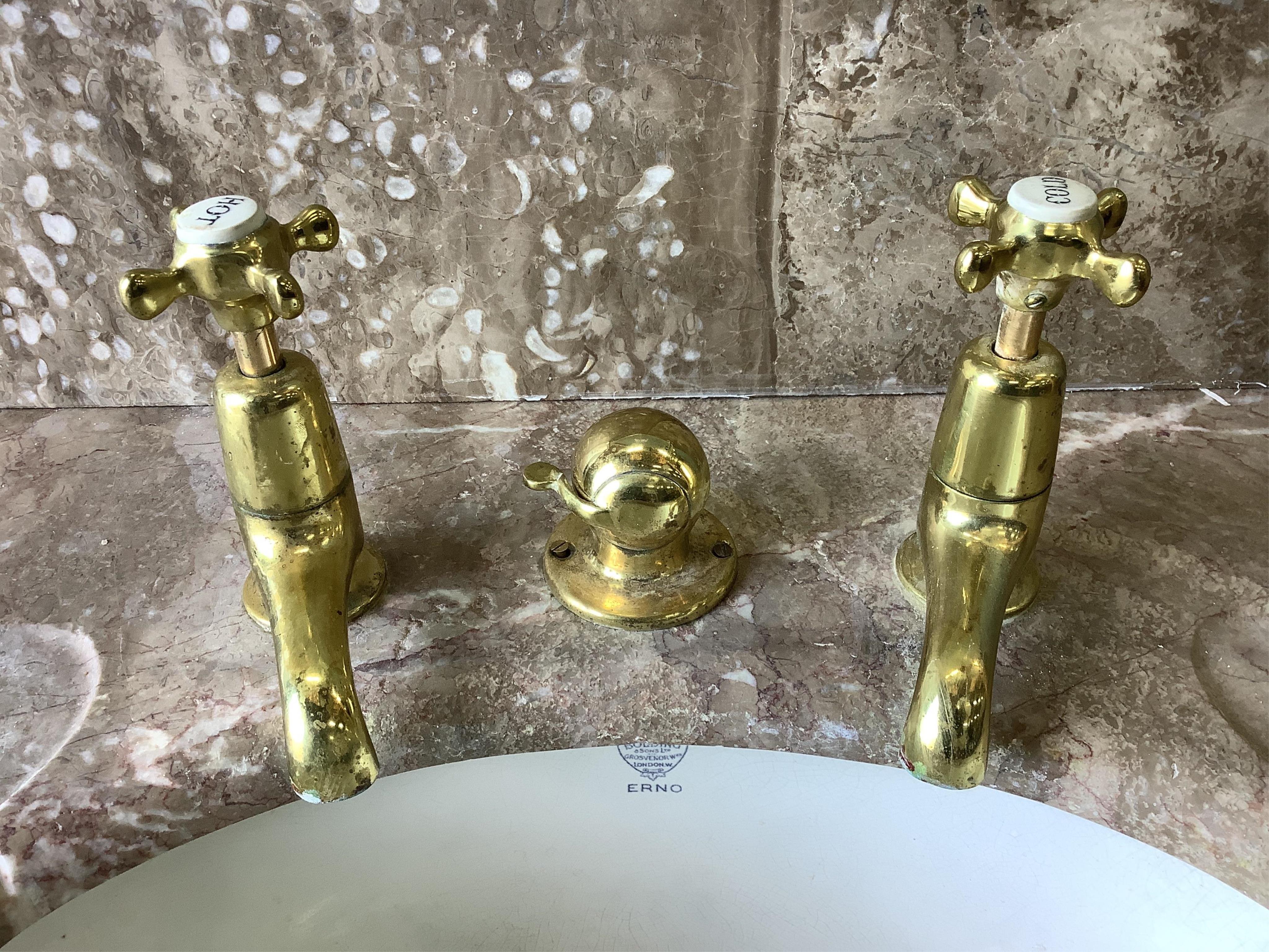 A marbled topped mahogany wash basin with John Bolding & Sons Erno ceramic basin and brass metal work, width 69cm, height 117cm. Condition - two old repair cracks to the marble top near front right, otherwise fair